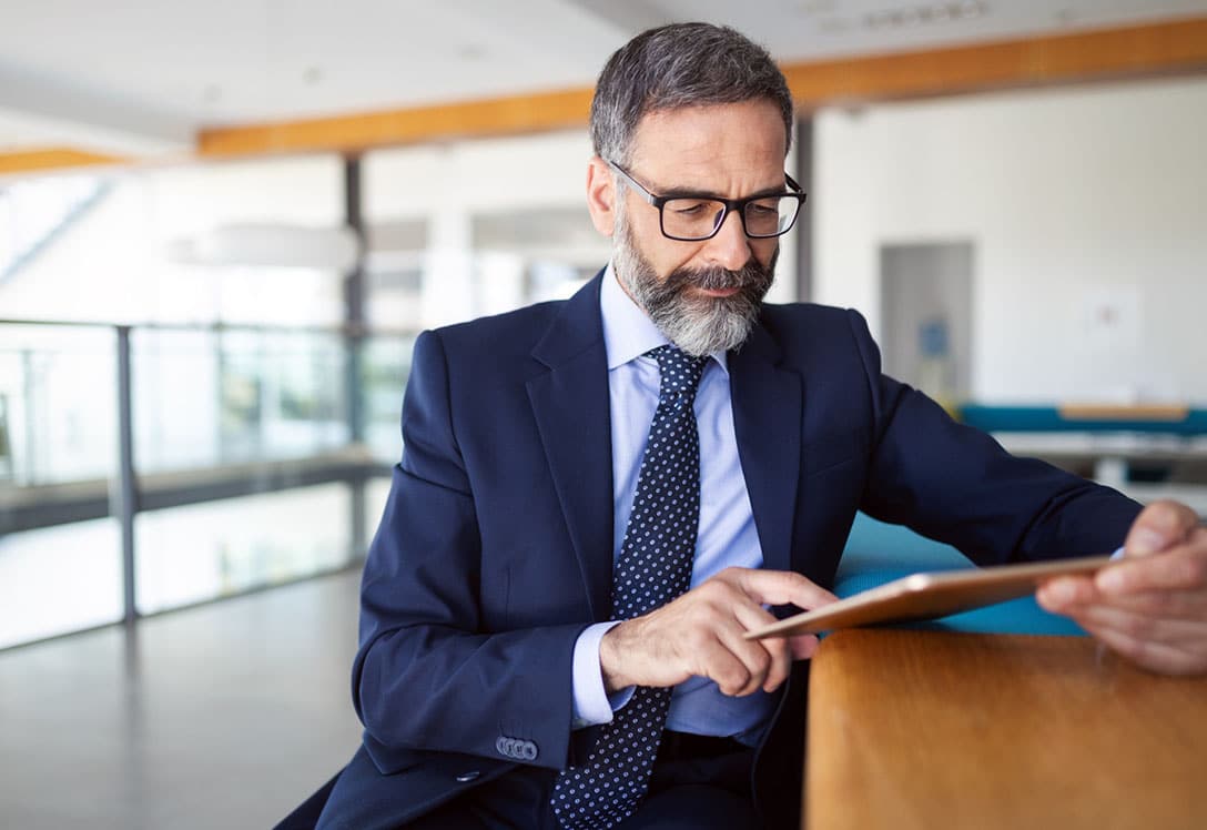 hombre con traje y gafas revisa la mutualidad laboral