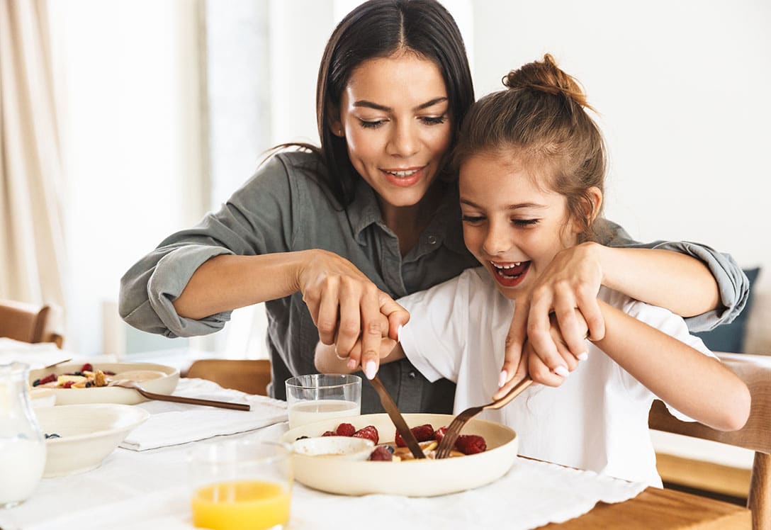 Madre e hija desayunando